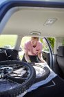 Cyclist placing bicycle in car boot — Stock Photo