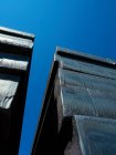 Bottom view of Steel billets against blue sky — Stock Photo