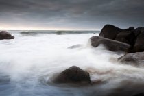 Волны, омывающие камни — стоковое фото
