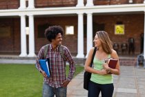 Students laughing together on campus — Stock Photo