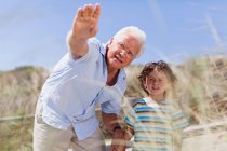 Older man and grandson standing outdoors — Stock Photo