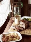 Rustic table with roasted goose on chopping board — Stock Photo