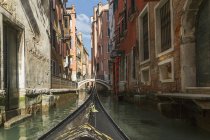 Part gondola with canal bridge in distance — Stock Photo