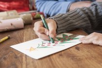 Boys hand drawing christmas tree — Stock Photo