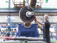 Engineer assembling industrial gearbox in engineering factory — Stock Photo
