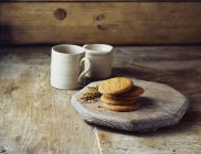 Wheat digestive biscuits on cutting board — Stock Photo