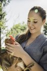 Woman holding chicken looking down smiling — Stock Photo
