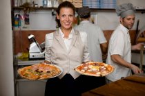 People in a pizzaria — Stock Photo