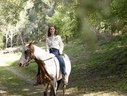 Portrait of teenage girl bareback riding horse — Stock Photo