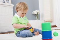 Baby boy playing with plastic toys — Stock Photo