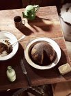 Dish of steamed treacle pudding and teapot — Stock Photo