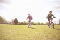 Garçons faisant du vélo sur un terrain de jeu à Londres, Royaume-Uni — Photo de stock