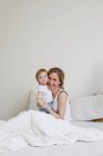 Portrait of mid adult woman and toddler baby girl — Stock Photo