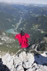 Mature man BASE jumping from mountain, Alleghe, Dolomites, Italy — Stock Photo