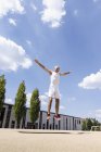 Mature man doing jump exercise in park — Stock Photo
