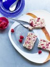 Plate of sliced masala fruit bread with raspberries — Stock Photo