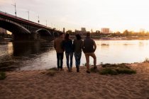 Four friends by river, Warsaw, Poland — Stock Photo