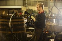 Male cooper making whisky casks in cooperage — Stock Photo