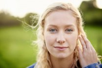 Close up portrait of young woman with blond hair — Stock Photo