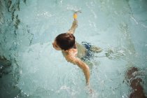 High angle view of boy treating water in swimming pool — Stock Photo