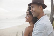 Smiling couple looking out over beach, Rio De Janeiro, Brazil — Stock Photo