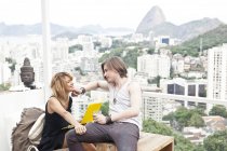Молодая пара с ноутбуком на террасе на крыше, Рио-де-Жанейро, Бразилия — стоковое фото