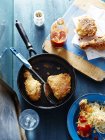Fried chicken with spatula in pan — Stock Photo