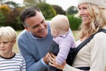 Family with baby outdoors — Stock Photo