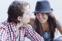 Young couple smiling, woman wearing hat — Stock Photo