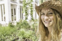 Young woman wearing straw hat, portrait — Stock Photo