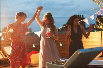 Friends dancing at early evening party — Stock Photo