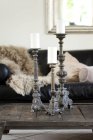 Three vintage candlesticks of living room coffee table — Stock Photo