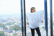 Mature architect in front of office window with Brussels cityscape, Belgium — Stock Photo