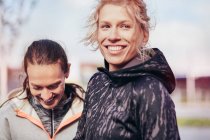 Two happy female runners in city — Stock Photo