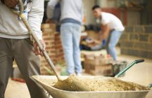 Cropped shot of three male college students in bricklaying workshop — Stock Photo