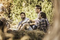Four male hikers taking a break in forest, Deer Park, Cape Town, South Africa — Stock Photo