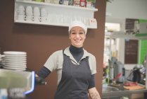Female Barista working at cafe and smiling — Stock Photo