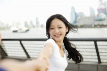 Young woman dancing with boyfriend on the waterfront, The Bund, Shanghai, China — Stock Photo