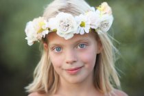 Portrait of girl with flower garland in her hair — Stock Photo