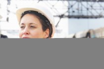 Portrait of female dockworker looking away — Stock Photo