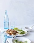 Roasted prawns, lime and mint dish on table — Stock Photo