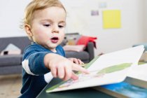 Boy pointing at book — Stock Photo