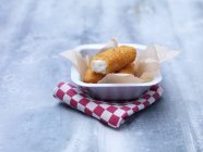 Fried chunky breaded cod fish fingers in baking tin on steel table — Stock Photo