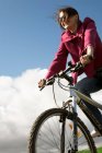 Woman riding a bike outdoors — Stock Photo