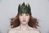 Young woman wearing crown of leaves — Stock Photo