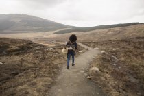 Donna che cammina sul sentiero, Piscine delle fate, Isola di Skye, Ebridi, Scozia — Foto stock