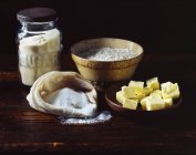 Flour, sugar and butter on wooden surface — Stock Photo