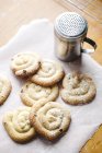 Homemade biscuits with icing sugar on table — Stock Photo