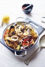 Bowl of seafood paella on table — Stock Photo