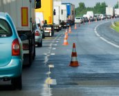 Rear view of rows of traffic queueing on highway with traffic cones — Stock Photo